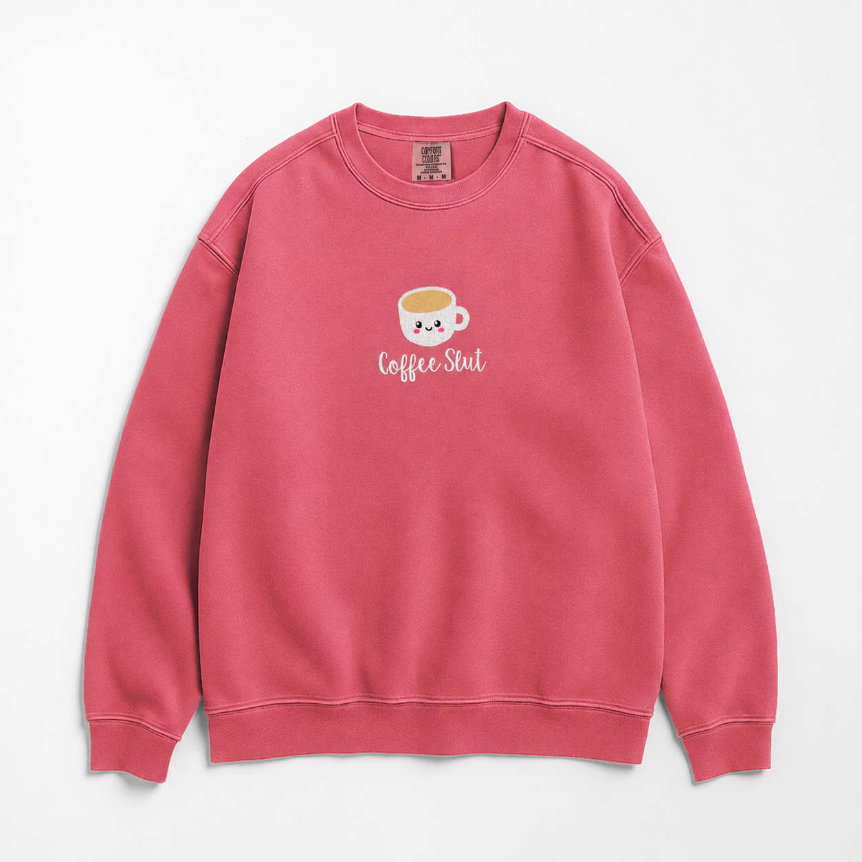 A pink crewneck sweatshirt featuring an embroidered coffee cup with 'Coffee Slut' written on the chest, displayed against a clean white background.