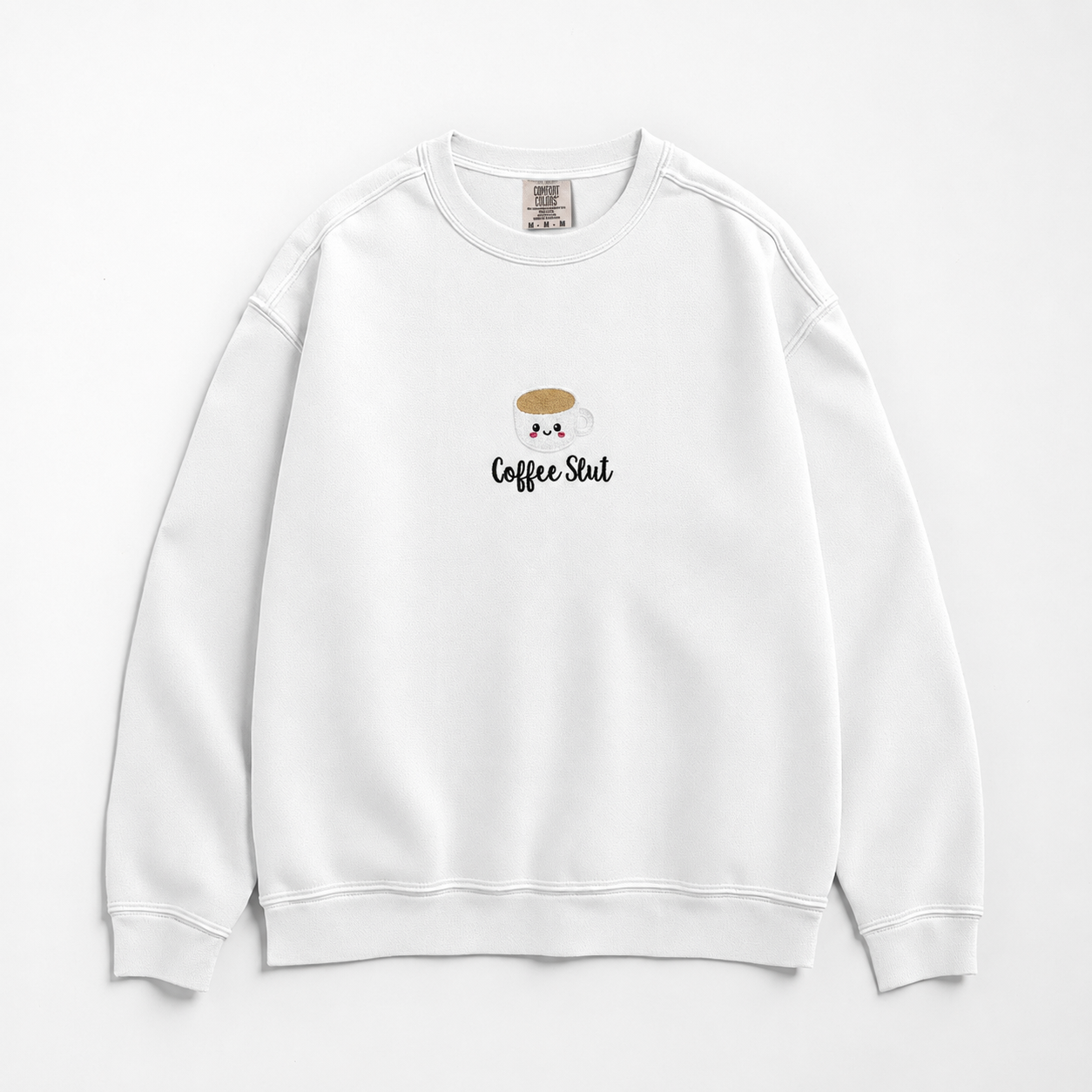 A white crewneck sweatshirt featuring a small embroidered coffee cup with the text 'Coffee Slut' on the chest, displayed against a clean white background.