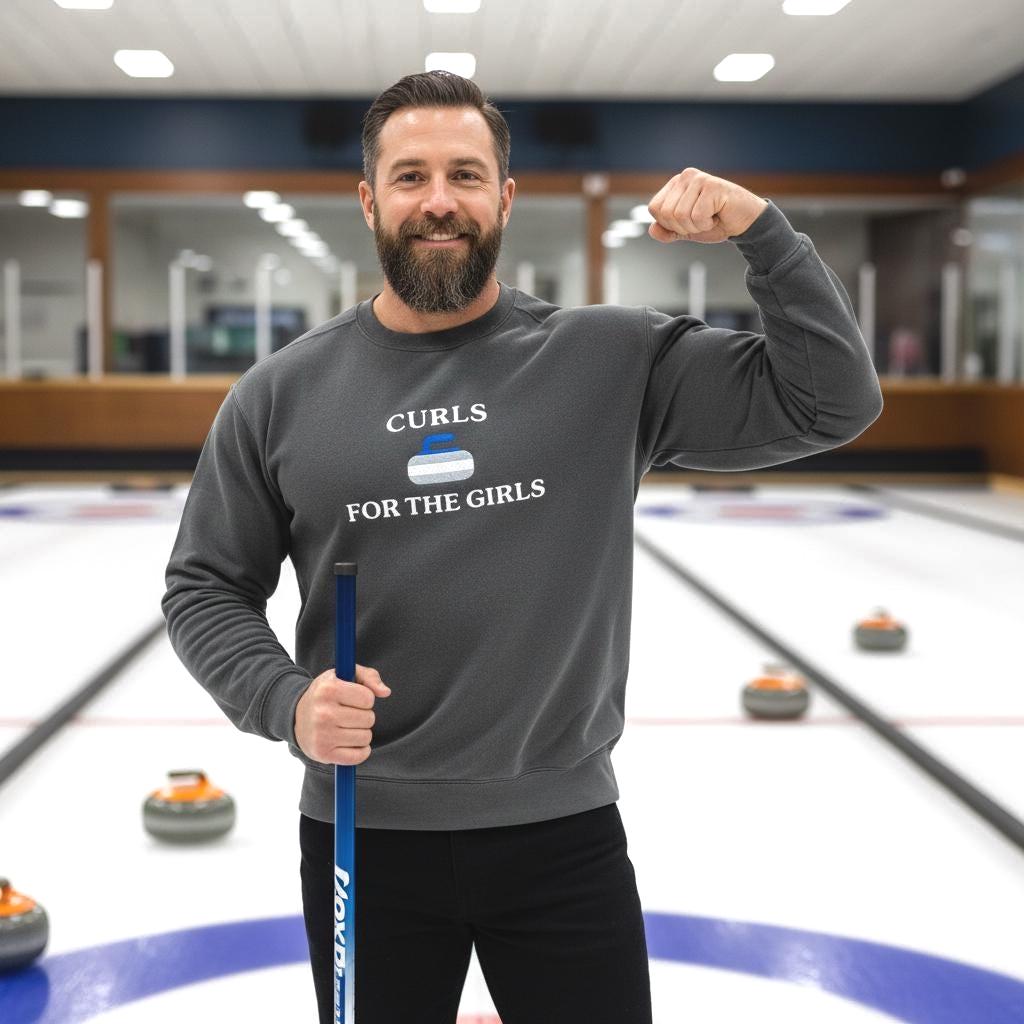 Man at the an indoor curling rink wearing a CURLS FOR THE GIRLS embroidered on the sweater.