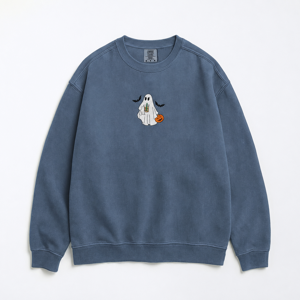 A dusty blue crewneck sweatshirt featuring a small embroidered cartoon ghost holding an orange pumpkin on the center chest, displayed flat against a clean white background.
