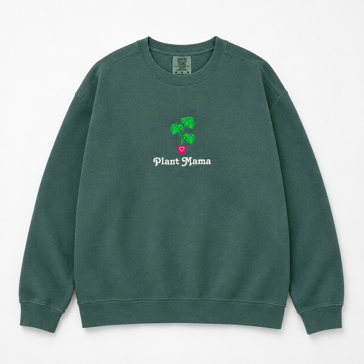 A dark green crewneck sweatshirt featuring an embroidered monstera plant with in a pink pot and the text 'Plant Mama' in white gothic font.