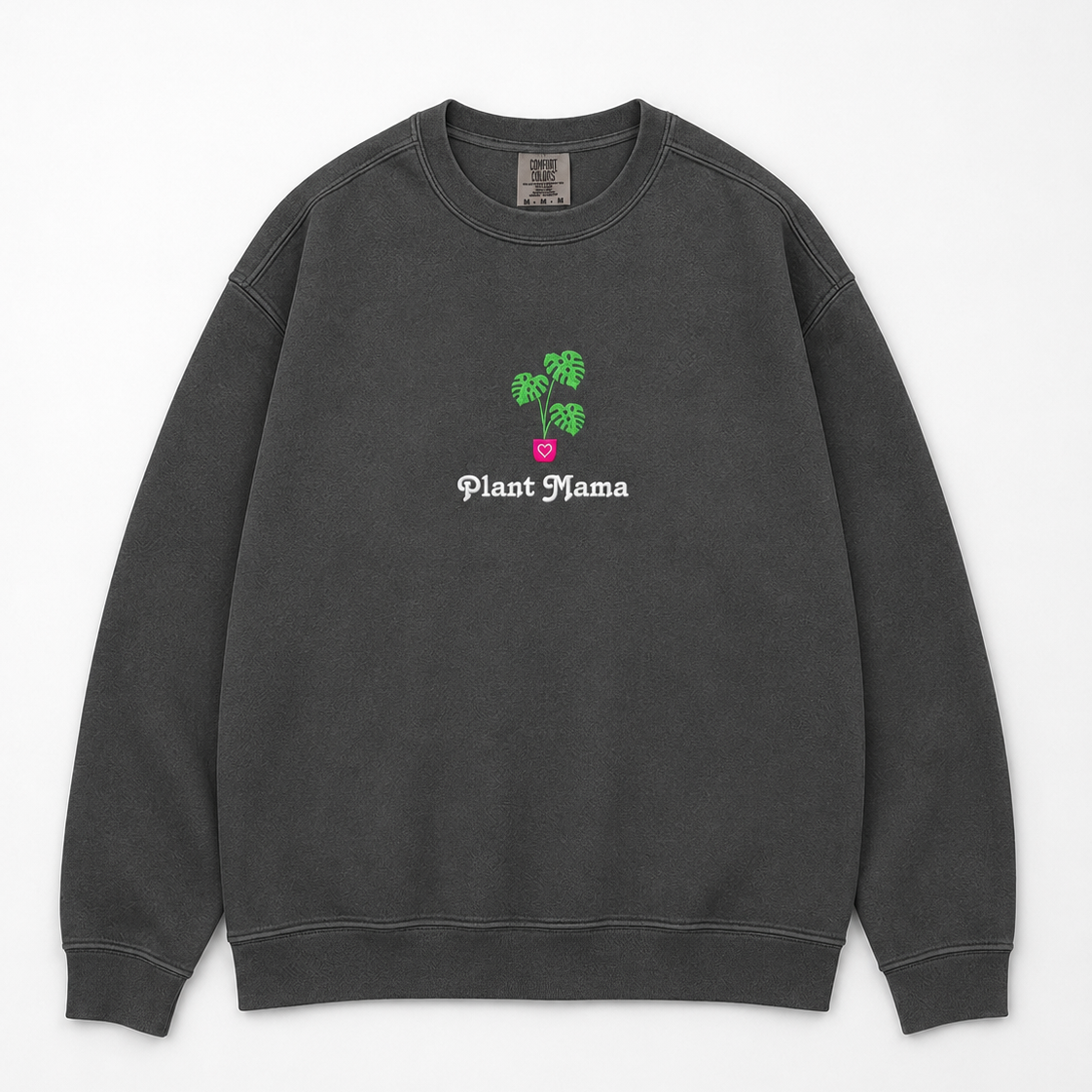 A dark gray crewneck sweatshirt featuring an embroidered monstera plant with in a pink pot and the text 'Plant Mama' in white gothic font.