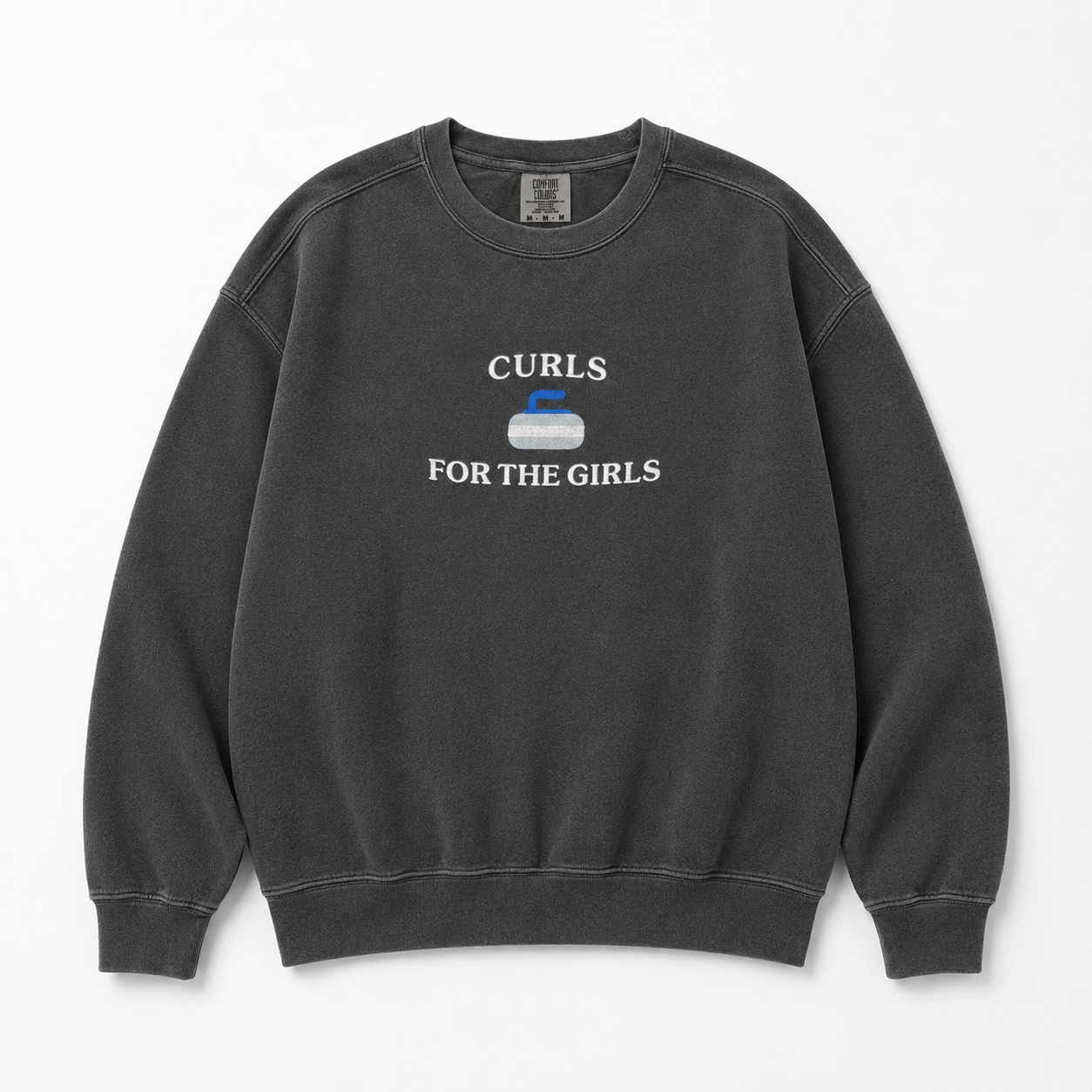 A dark gray washed crewneck sweatshirt featuring a white graphic embroidered that reads 'CURLS FOR THE GIRLS' with a curling stone icon in the center, displayed flat against a light gray background.