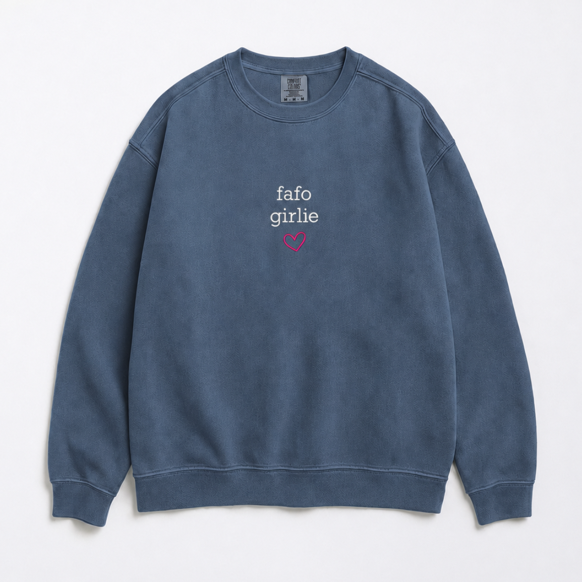A faded blue crewneck sweatshirt with 'fafo girlie' printed in white and a small pink heart on the chest, displayed flat against a light gray background.