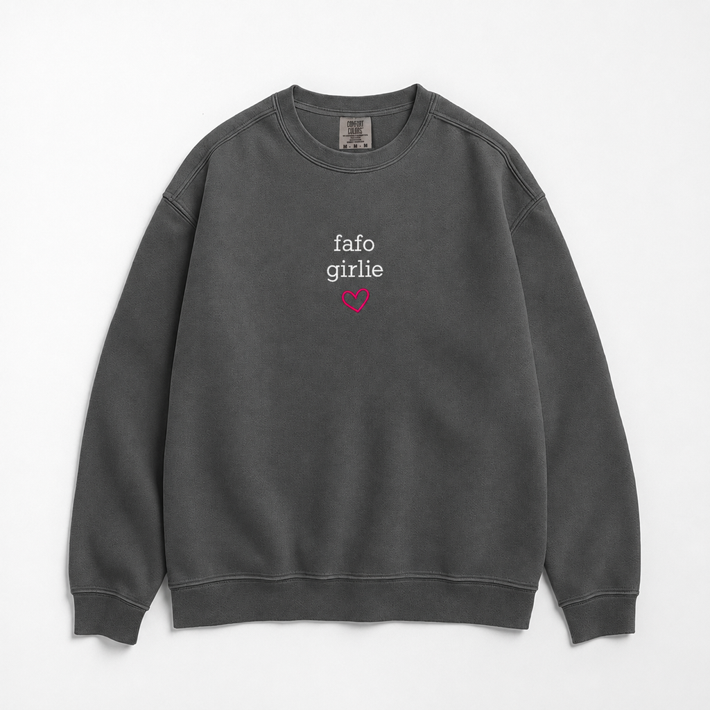 A dark gray crewneck sweatshirt with 'fafo girlie' printed in white text and a small pink heart underneath on the chest, displayed flat against a light gray background.