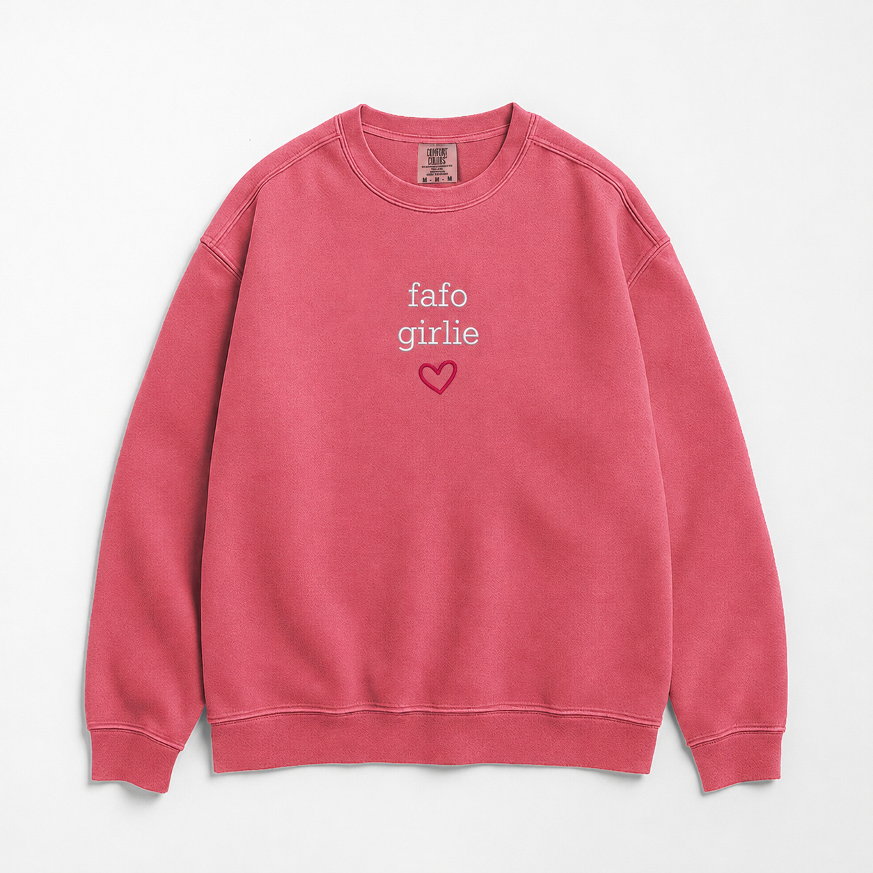 A pink crewneck sweatshirt with 'fafo girlie' and a small heart printed on the chest, displayed flat against a light gray background.