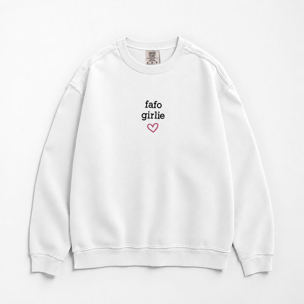 A white crewneck sweatshirt with 'fafo girlie' printed in black text and a small pink heart outline on the chest, displayed flat against a white background.