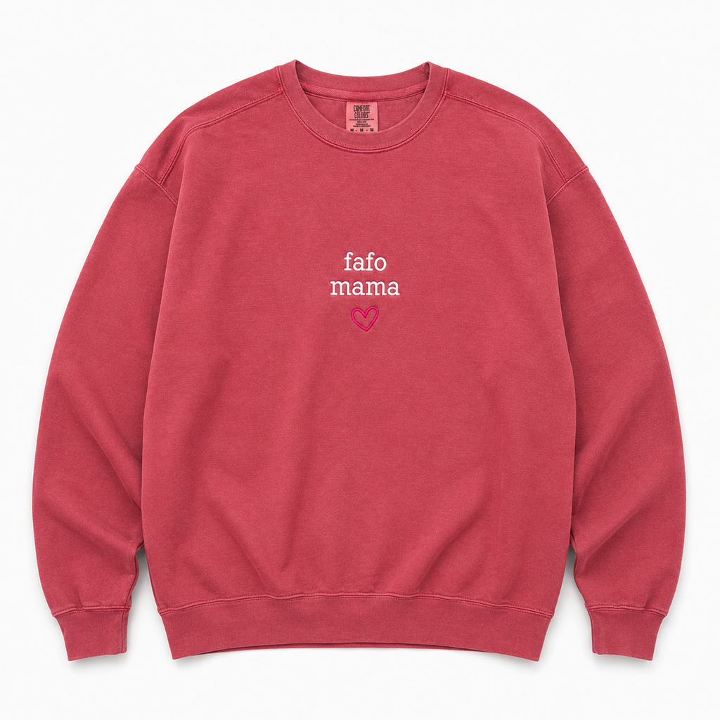 A dusty rose crewneck sweatshirt featuring  'fafo mama' embroidered in white and a small pink heart on the chest, displayed flat against a light gray background.