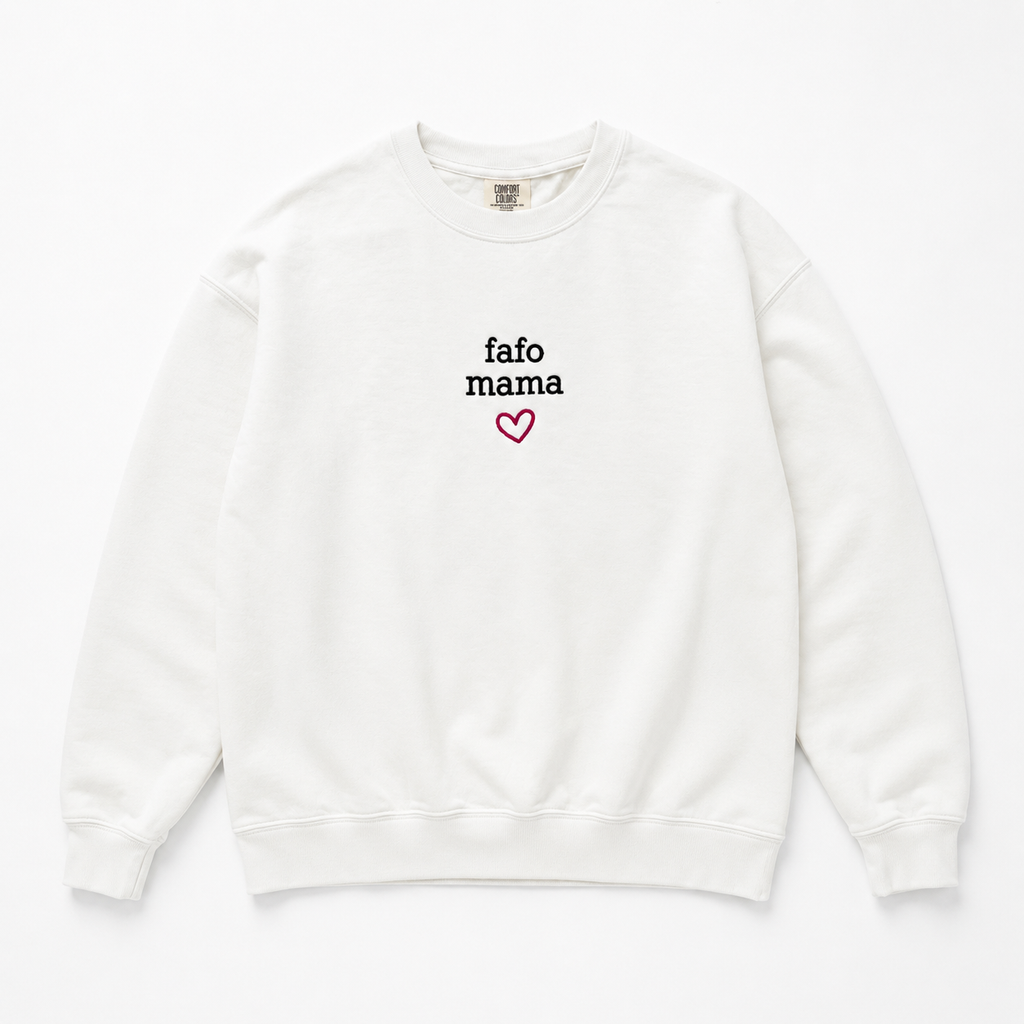 An off-white crewneck sweatshirt featuring the text 'fafo mama' in black and a small pink heart outline embroidered on the center chest, displayed on a clean white background.