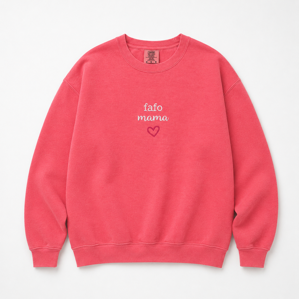 A coral pink crewneck sweatshirt with 'fafo mama' and a small heart embroidered on the chest, displayed flat against a light gray background.