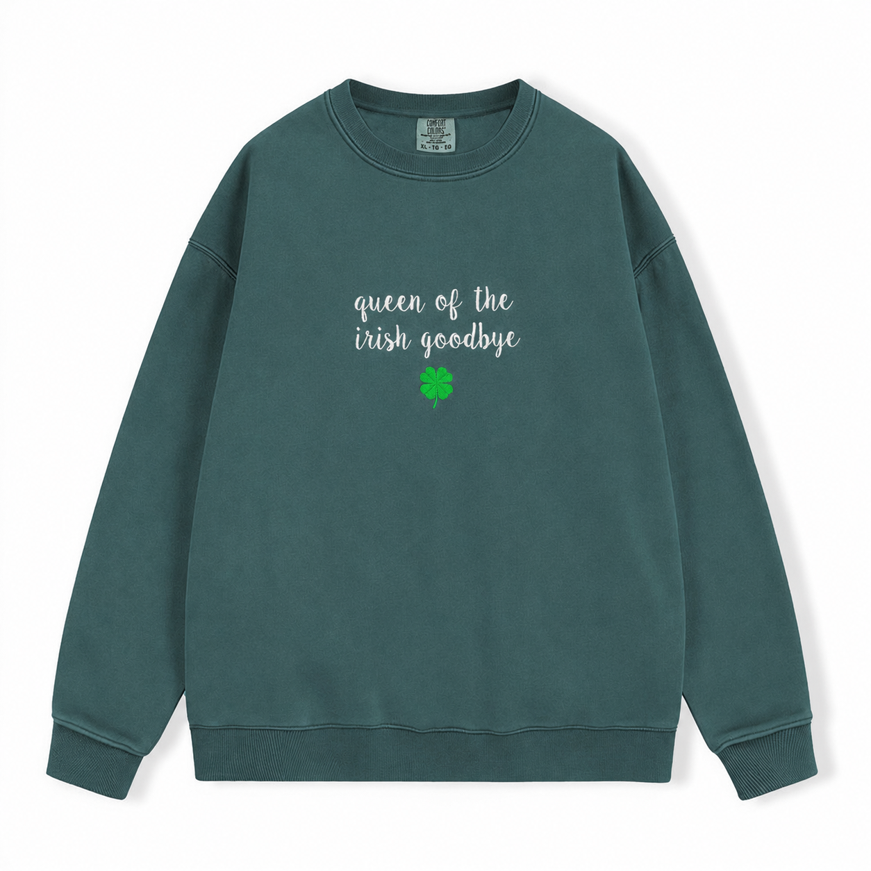 A dark green crewneck sweatshirt embroidered with 'queen of the irish goodbye' in white script and a green four leaf shamrock on a white background.